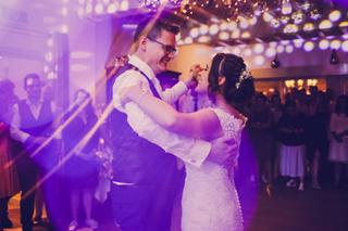 Bruidspaar Yuri en Joyce danst tijdens trouwreportage, paarse feestverlichting, bruiloft Boswachter Breda - Trouwshoot Stefan