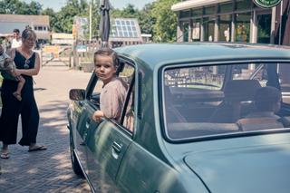 Bruidskindje in vintage auto op De Schaapskooi in Delft – een moment van puurheid en plezier - Trouwshoot Stefan Segers