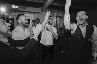 Bruidegom Robbert en gasten dansen feestelijk op bruiloft Ilse en Robbert, trouwreportage Boerderij Burgersdijk De Lier - Tro