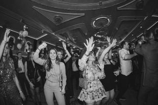 Bruiloftsgasten dansen uitgelaten op trouwfeest, zwart-witfoto van festive sfeer op dancefloor - Trouwshoot Stefan Segers