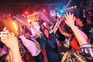 Bruidspaar Liad en Wilfried dansen uitbundig met gasten op trouwfeest The Boathouse Kralingen, feestelijke trouwreportage - T