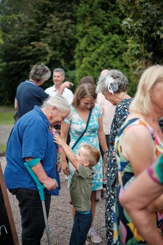 Grootmoeder en kleine jongen genieten samen op het jubileumfeest bij Wantijpaviljoen - Trouwshoot Stefan Segers